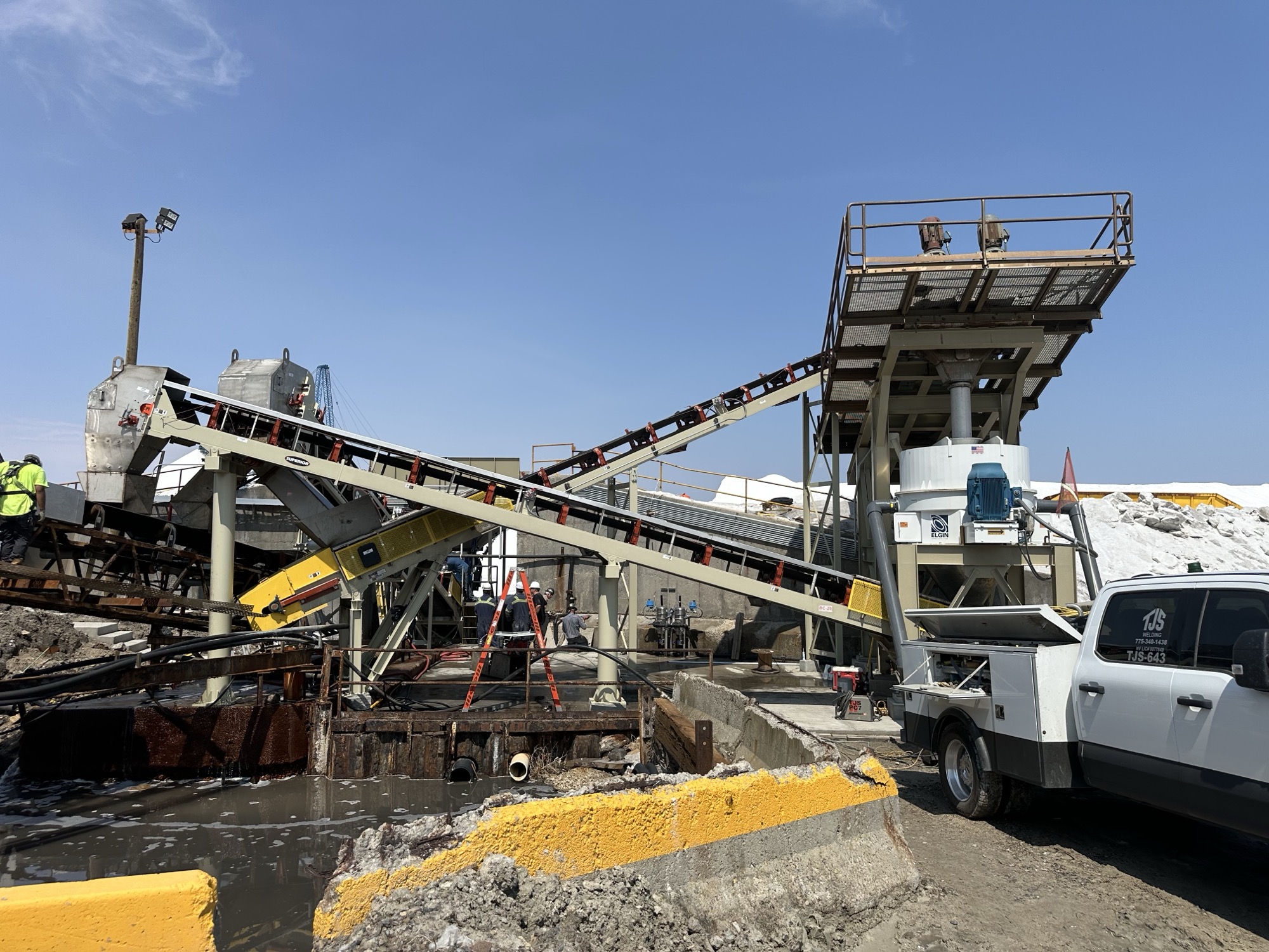 Dewatering and separation systems including centrifuges, air bed dryers and rotating kilns