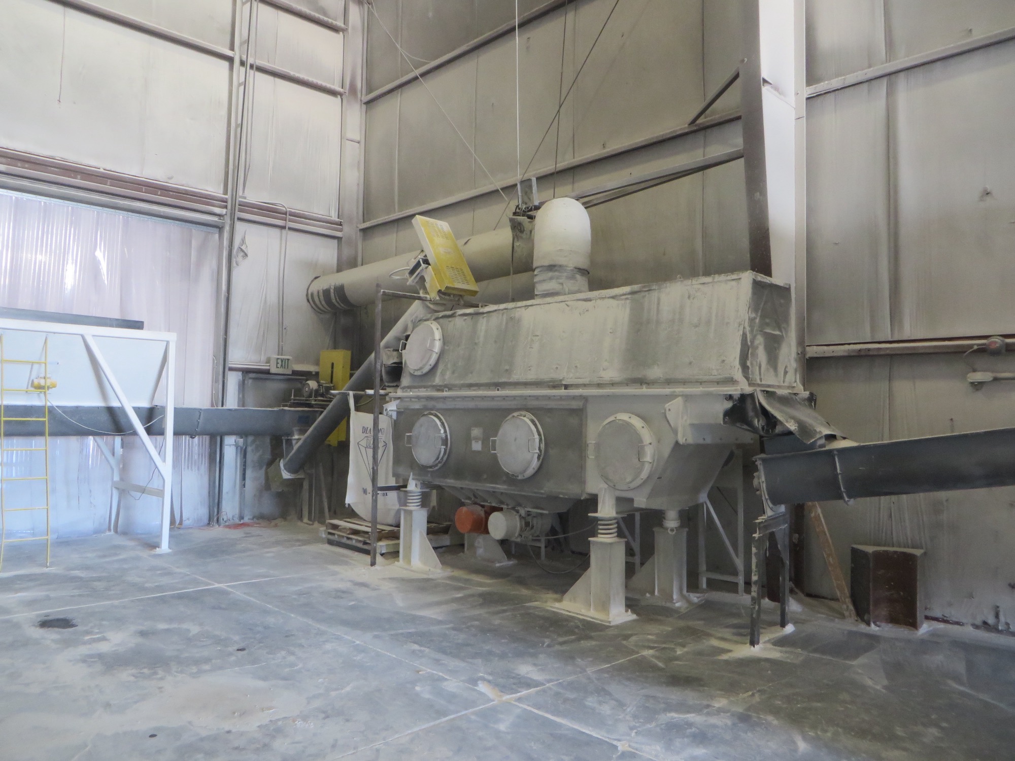 Dewatering and separation systems including centrifuges, air bed dryers and rotating kilns